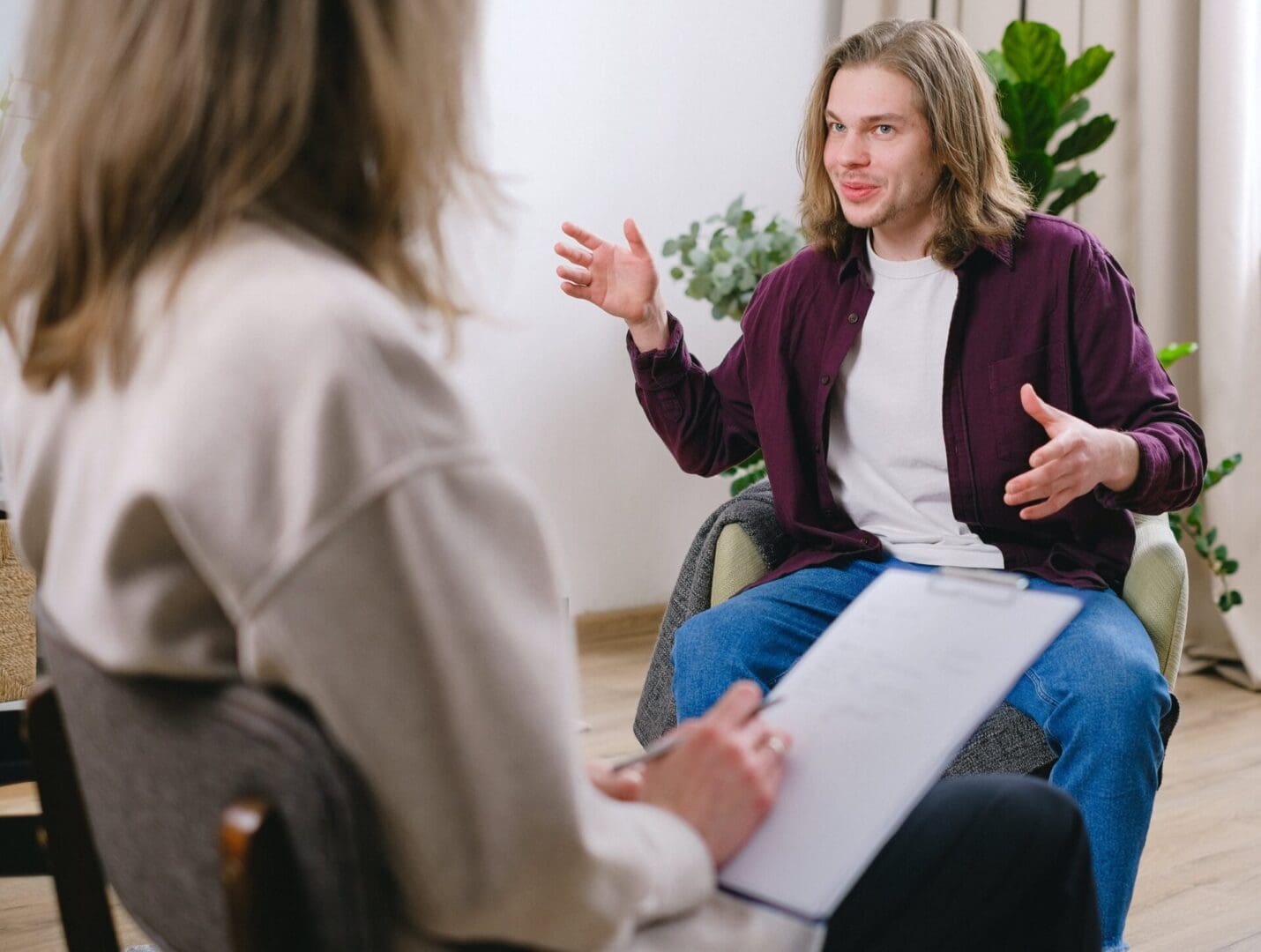 A man sitting in front of another person.